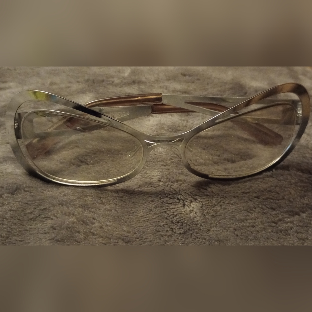 Vintage Spacey glasses with silver metallic exterior and interior. Has brown tip